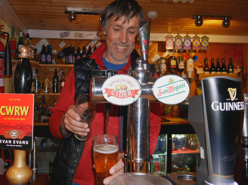 Barman serving a pints of Cider in The Paddlers Return