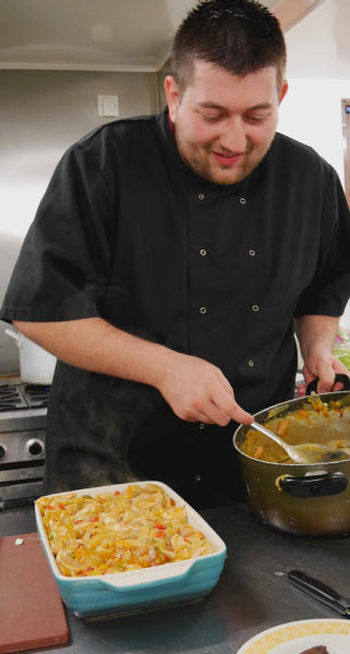 Head Chef preparing a pasta bake
